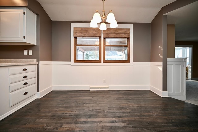 unfurnished dining area with lofted ceiling, a baseboard radiator, dark hardwood / wood-style floors, and a notable chandelier