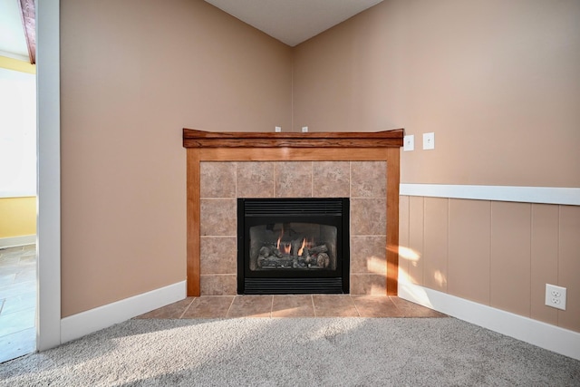 room details featuring carpet flooring and a tile fireplace