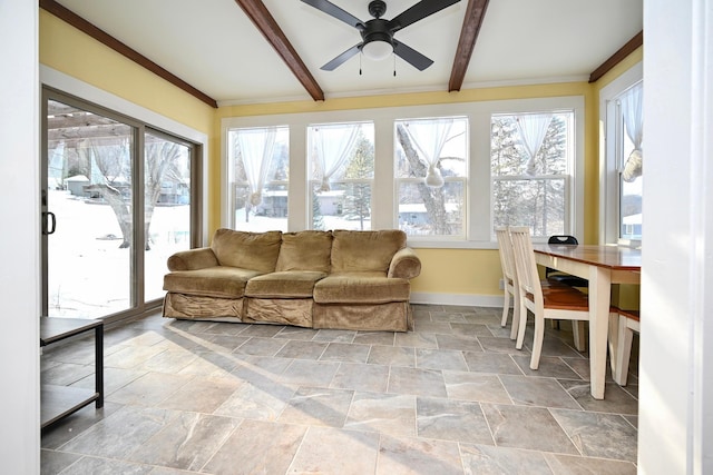 sunroom featuring beam ceiling and ceiling fan