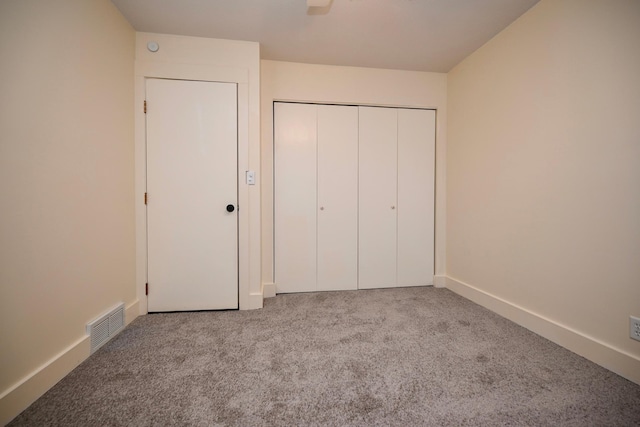 unfurnished bedroom with light carpet, a closet, and ceiling fan