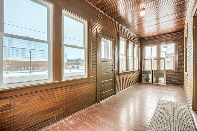 unfurnished sunroom featuring wooden ceiling