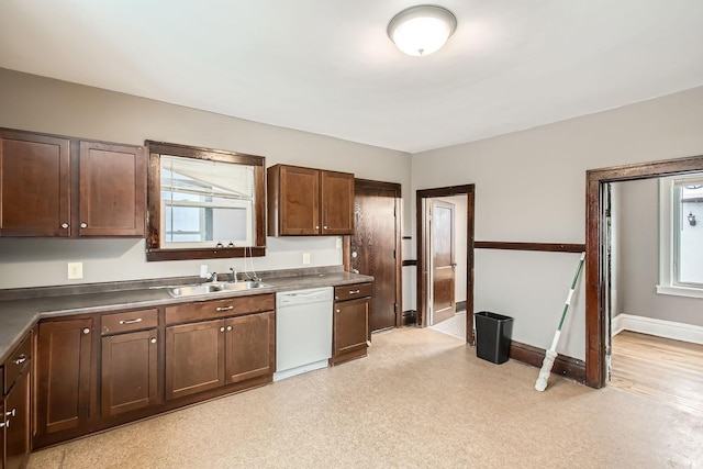 kitchen with dishwasher, dark brown cabinets, and sink