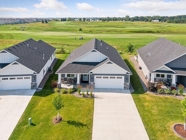 birds eye view of property with a rural view