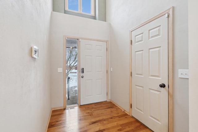 entrance foyer with light hardwood / wood-style flooring and a high ceiling