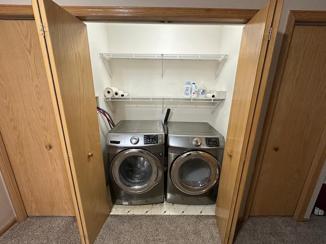 laundry room with light colored carpet and separate washer and dryer