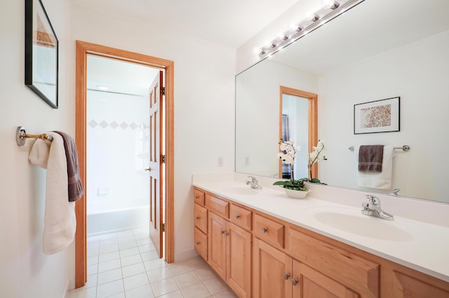 bathroom with double vanity, tile patterned flooring, and a sink