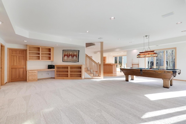 rec room featuring light carpet, a healthy amount of sunlight, built in study area, and recessed lighting