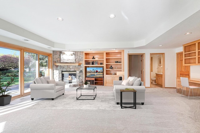 living room with carpet floors, recessed lighting, baseboards, and a stone fireplace