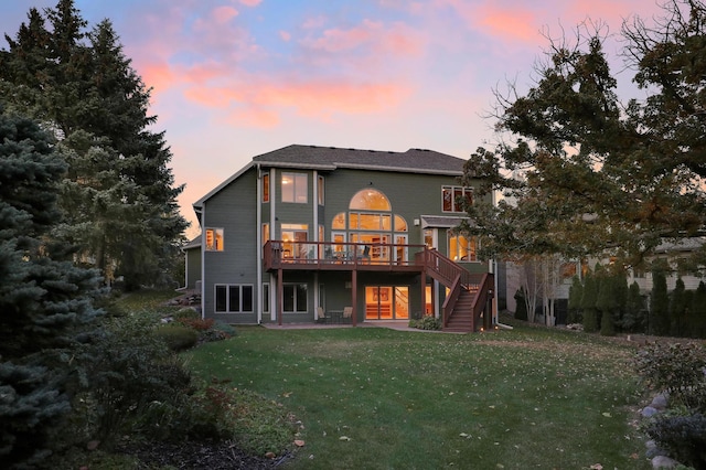 back of property with stairs, a yard, and a deck