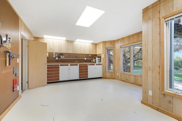 kitchen with wooden walls and finished concrete floors