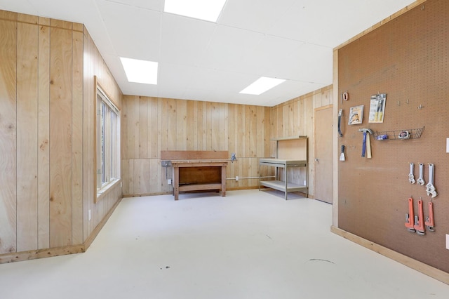 interior space with concrete floors and wooden walls