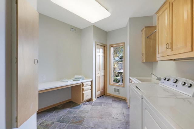 laundry area featuring visible vents, a sink, cabinet space, and washer and dryer