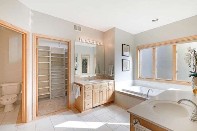 full bath with two vanities, a sink, toilet, and tile patterned floors