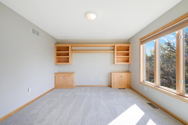 unfurnished room with light carpet, baseboards, and visible vents