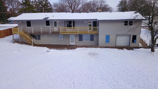 snow covered property featuring a garage