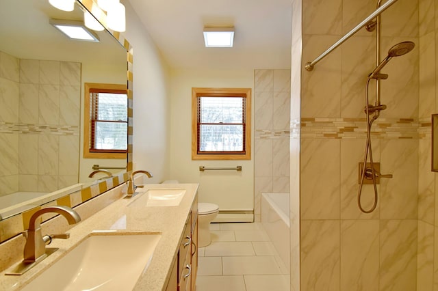 bathroom featuring tiled shower, vanity, tile patterned floors, and toilet