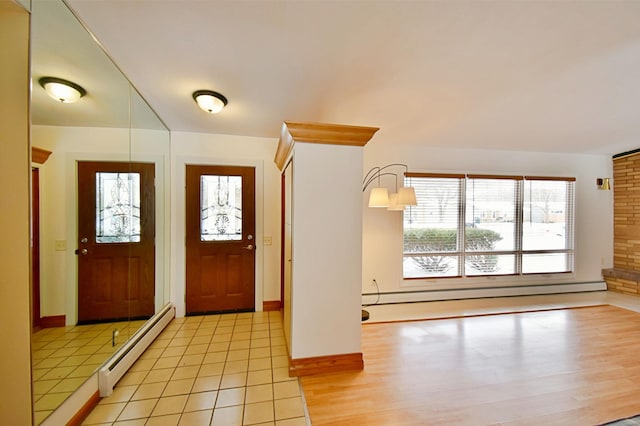 foyer with light tile patterned floors and a baseboard heating unit