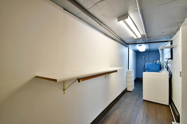 clothes washing area with dark hardwood / wood-style flooring