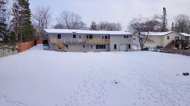 snow covered house with a garage