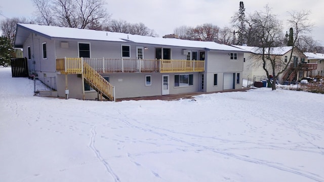 snow covered house with a garage