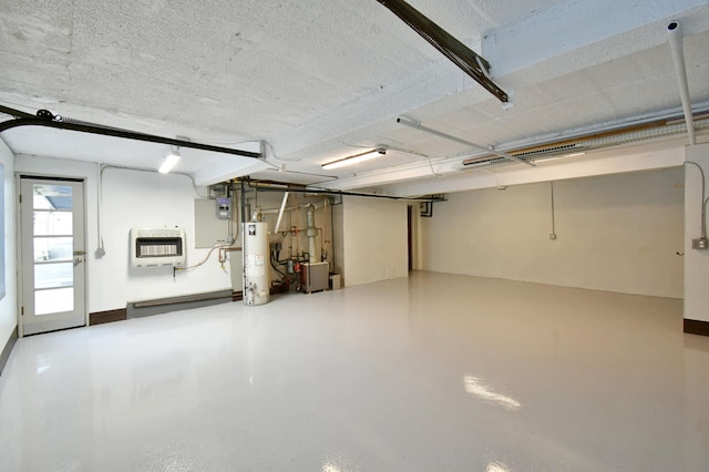 garage featuring heating unit and water heater