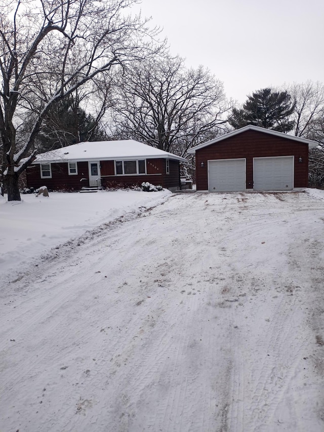 view of front facade featuring a garage and an outbuilding