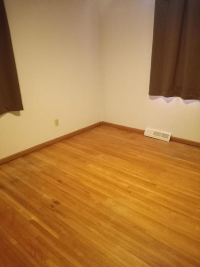 unfurnished room with light wood-type flooring