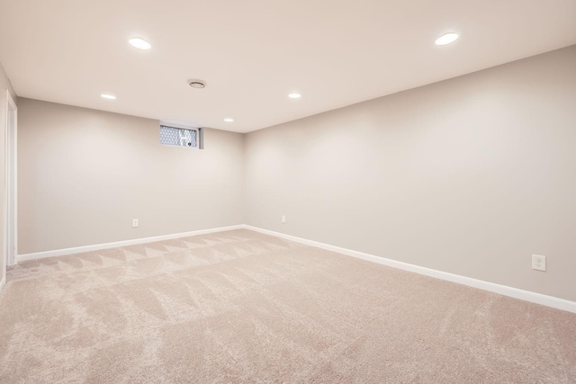 basement featuring light carpet