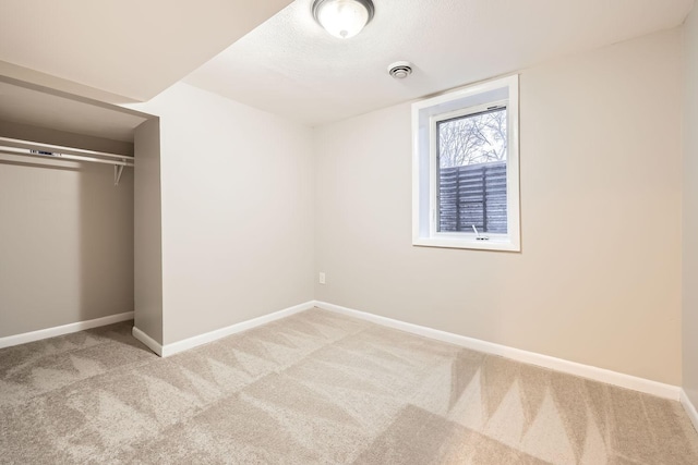 unfurnished bedroom featuring light carpet and a closet