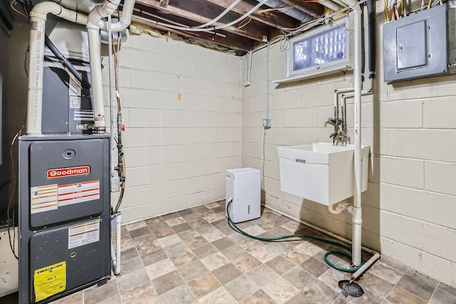 interior space with electric panel, heating unit, and sink