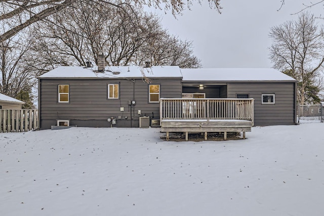 snow covered house featuring central AC