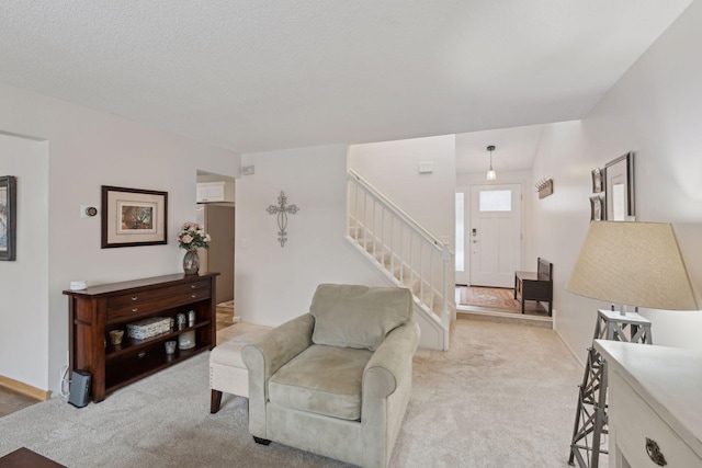 carpeted living room with a textured ceiling