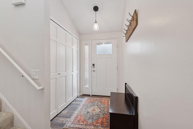 foyer featuring dark hardwood / wood-style floors and vaulted ceiling