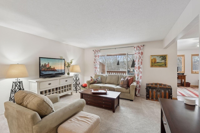 living room featuring light colored carpet and a textured ceiling