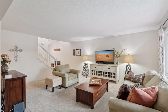 living room featuring light carpet and a textured ceiling