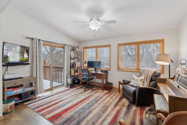 home office with lofted ceiling, ceiling fan, a textured ceiling, and hardwood / wood-style floors