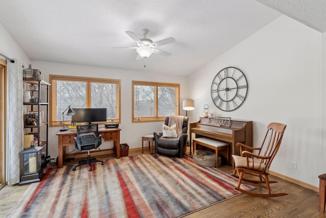 office area featuring light wood-type flooring, ceiling fan, and a textured ceiling