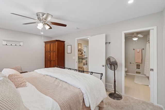 bedroom featuring ensuite bath, ceiling fan, and light carpet