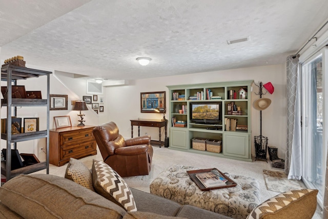 carpeted living room featuring a textured ceiling