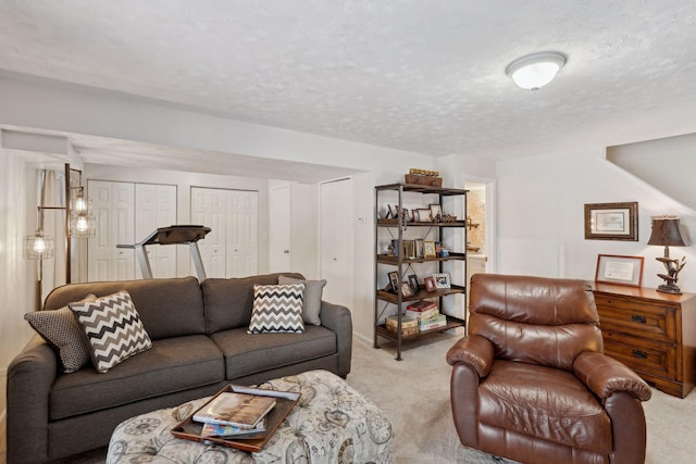 living room with light colored carpet and a textured ceiling