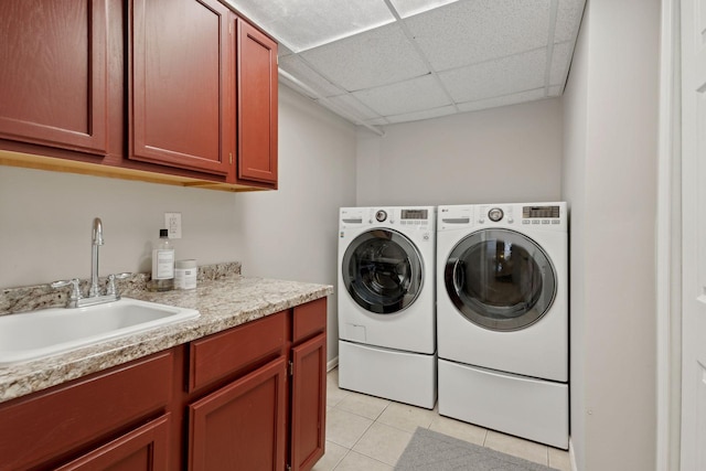 washroom featuring cabinets, sink, light tile patterned floors, and separate washer and dryer