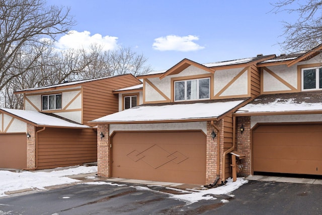 tudor-style house featuring a garage