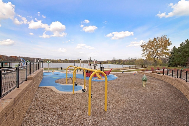 view of jungle gym featuring a water view