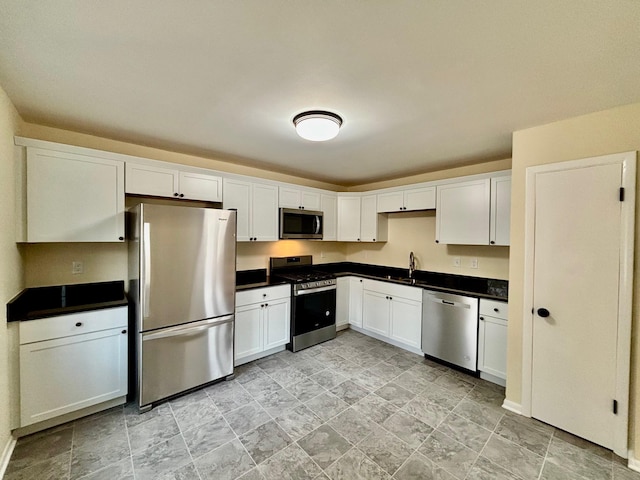 kitchen featuring white cabinets, stainless steel appliances, and sink