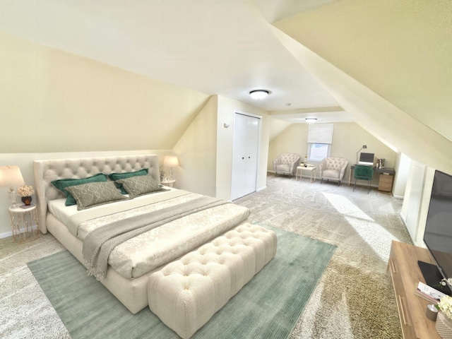 bedroom featuring lofted ceiling and light carpet