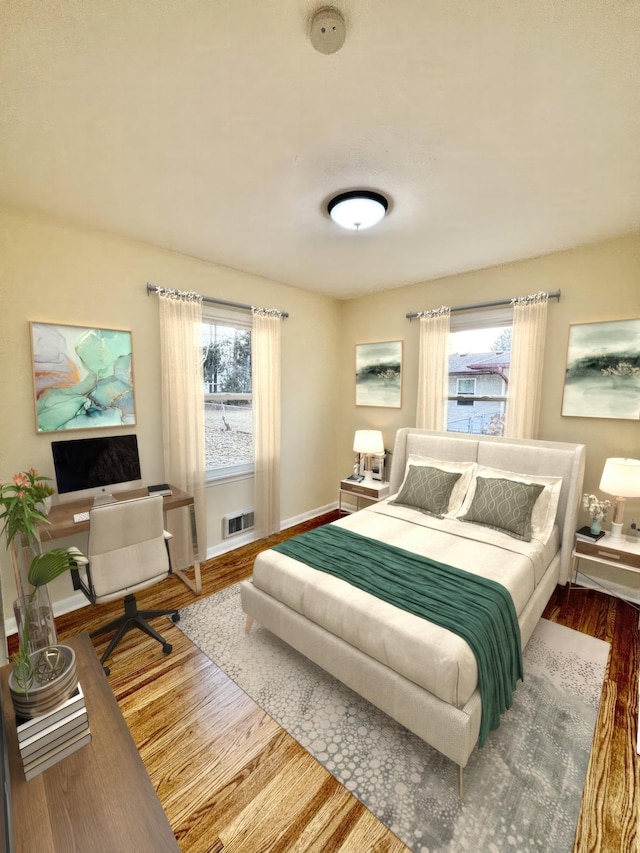 bedroom featuring multiple windows and hardwood / wood-style flooring