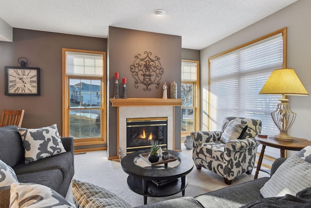 carpeted living room featuring a textured ceiling