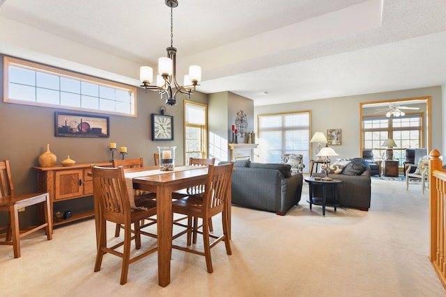 dining room featuring light carpet and a notable chandelier