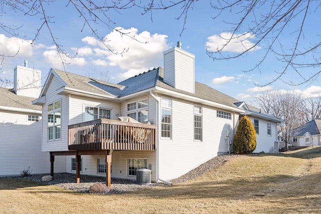 rear view of property with a wooden deck, a yard, and central AC