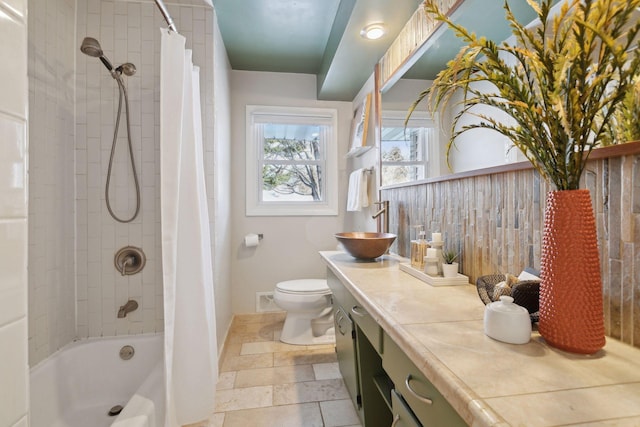 full bathroom featuring vanity, shower / bath combination with curtain, and toilet